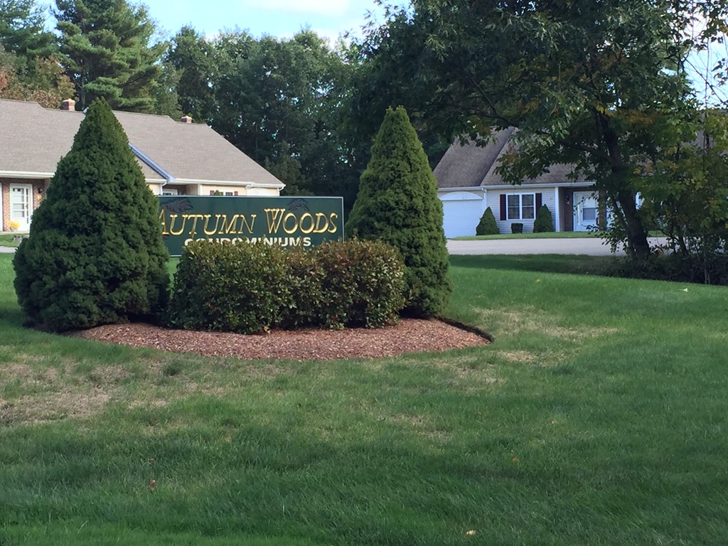 8 Autumn Woods Drive, Unit 8 Rutland, MA 01543 - Photo 16 of 16 a view of a house with a yard and a garden
