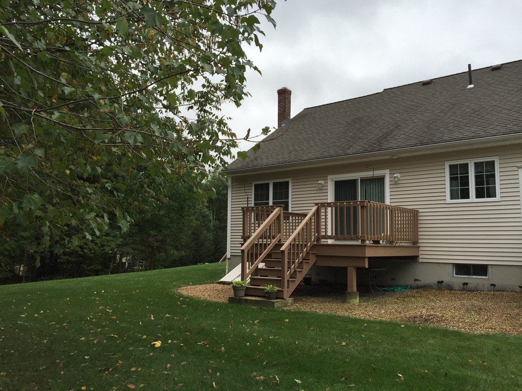 8 Autumn Woods Drive, Unit 8 Rutland, MA 01543 - Photo 3 of 16 a view of a house with a backyard