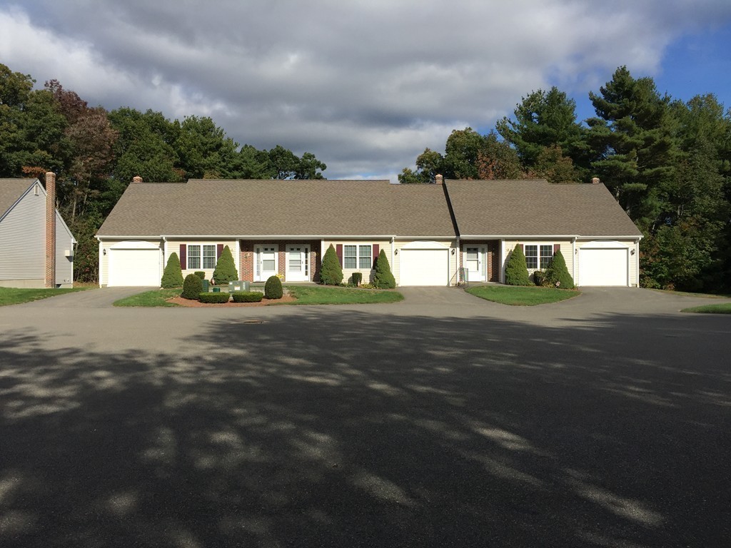 8 Autumn Woods Drive, Unit 8 Rutland, MA 01543 - Photo 4 of 16 a front view of a house with a yard