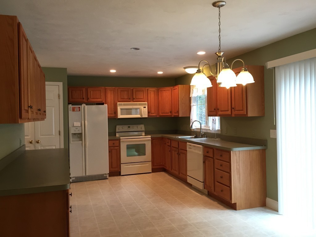 8 Autumn Woods Drive, Unit 8 Rutland, MA 01543 - Photo 6 of 16 a kitchen with stainless steel appliances granite countertop a stove a refrigerator and a sink