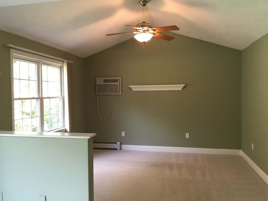 8 Autumn Woods Drive, Unit 8 Rutland, MA 01543 - Photo 7 of 16 an empty room with windows