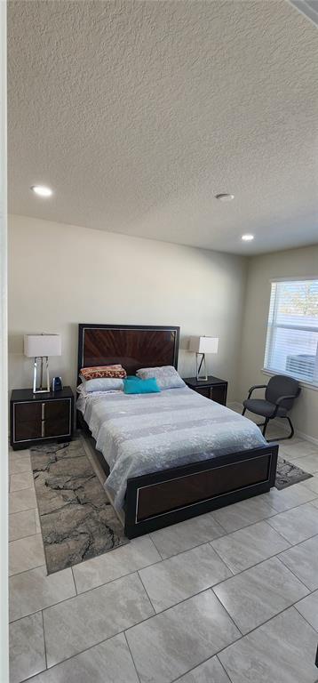 1823 Spring Shower Circle Kissimmee, FL 34744 - Photo 12 of 38 a bedroom with a bed and window