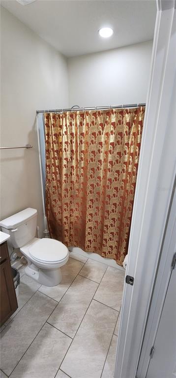 1823 Spring Shower Circle Kissimmee, FL 34744 - Photo 18 of 38 a bathroom with a toilet and a shower curtain