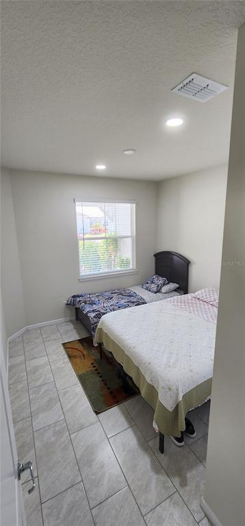 1823 Spring Shower Circle Kissimmee, FL 34744 - Photo 21 of 38 a bedroom with a bed and window