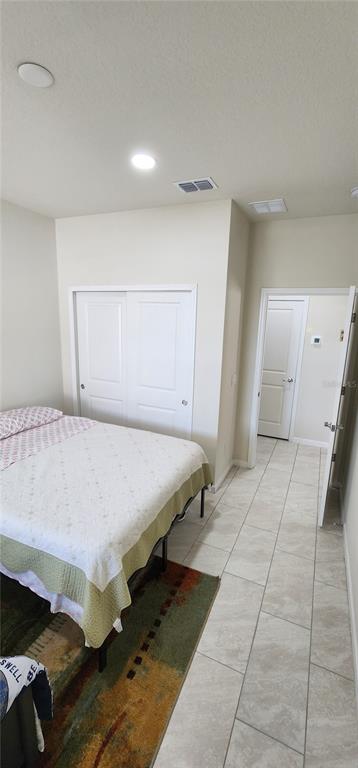 1823 Spring Shower Circle Kissimmee, FL 34744 - Photo 22 of 38 a spacious bedroom with a bed and a cabinets