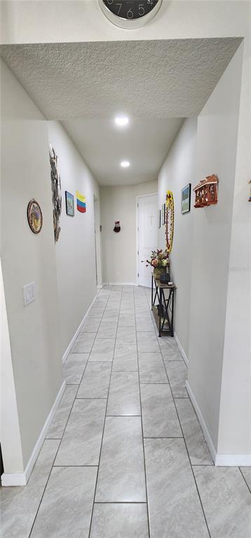 1823 Spring Shower Circle Kissimmee, FL 34744 - Photo 23 of 38 a hallway with table and a potted plant