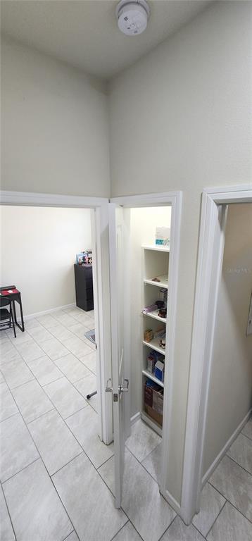 1823 Spring Shower Circle Kissimmee, FL 34744 - Photo 26 of 38 a view of a refrigerator in kitchen and an empty room