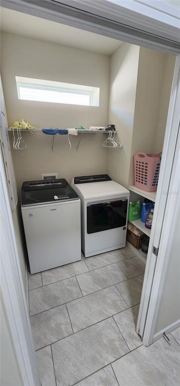 1823 Spring Shower Circle Kissimmee, FL 34744 - Photo 27 of 38 a kitchen with a stove and white cabinets
