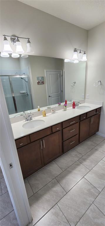 1823 Spring Shower Circle Kissimmee, FL 34744 - Photo 9 of 38 a bathroom with a sink vanity and mirror