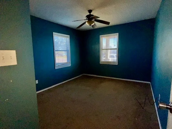 a view of empty room with windows