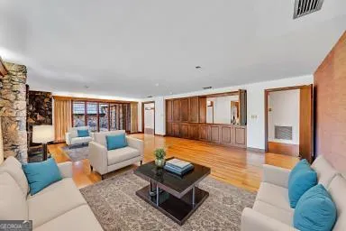 a living room with furniture and a rug