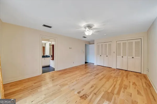a bathroom with a granite countertop double sink and a mirror
