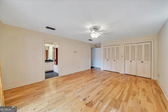 a bathroom with a granite countertop double sink and a mirror