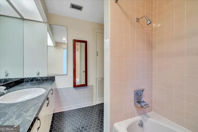 a view of a big room with closet and a chandelier fan