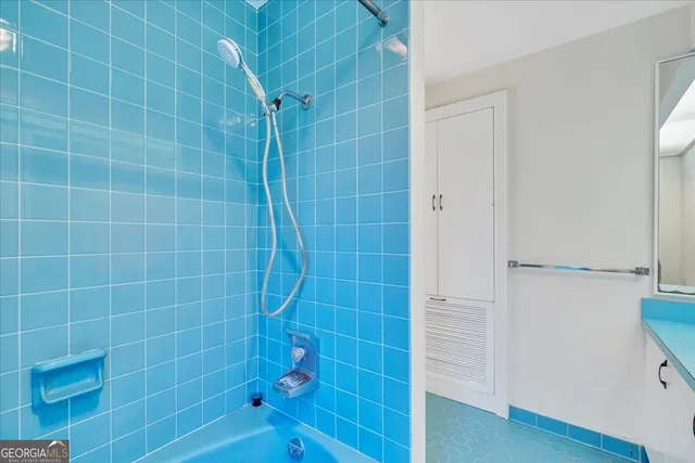 a view of a livingroom with a ceiling fan and window