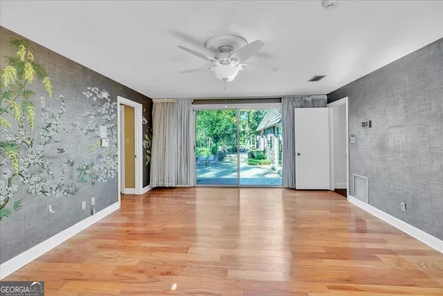 a bedroom with a large bed and a flat screen tv