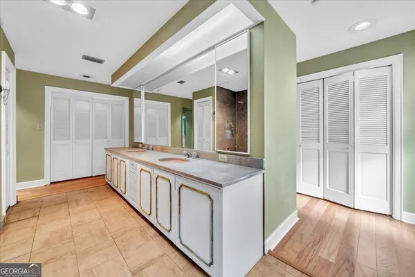 a bathroom with a tub a shower and a sink