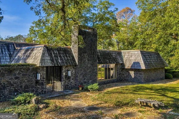 a view of a houses with an outdoor space and trees
