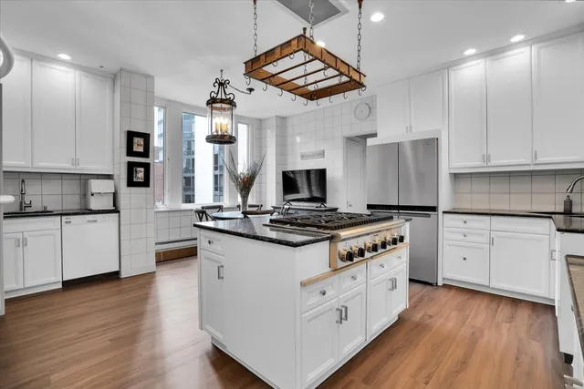 a kitchen with stainless steel appliances granite countertop a stove and a sink