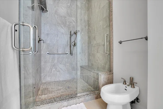 a bathroom with a shower and sink