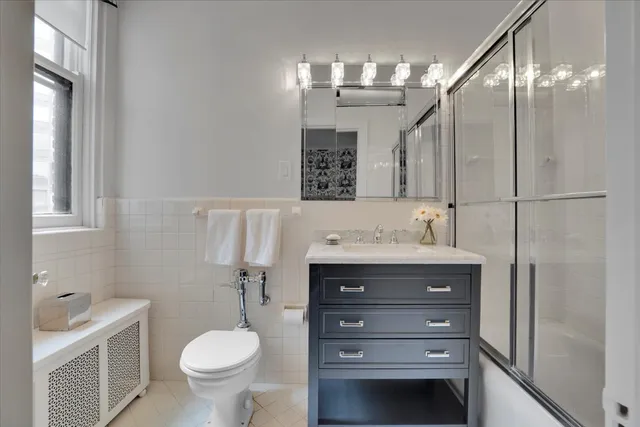 a bathroom with a sink toilet and a mirror