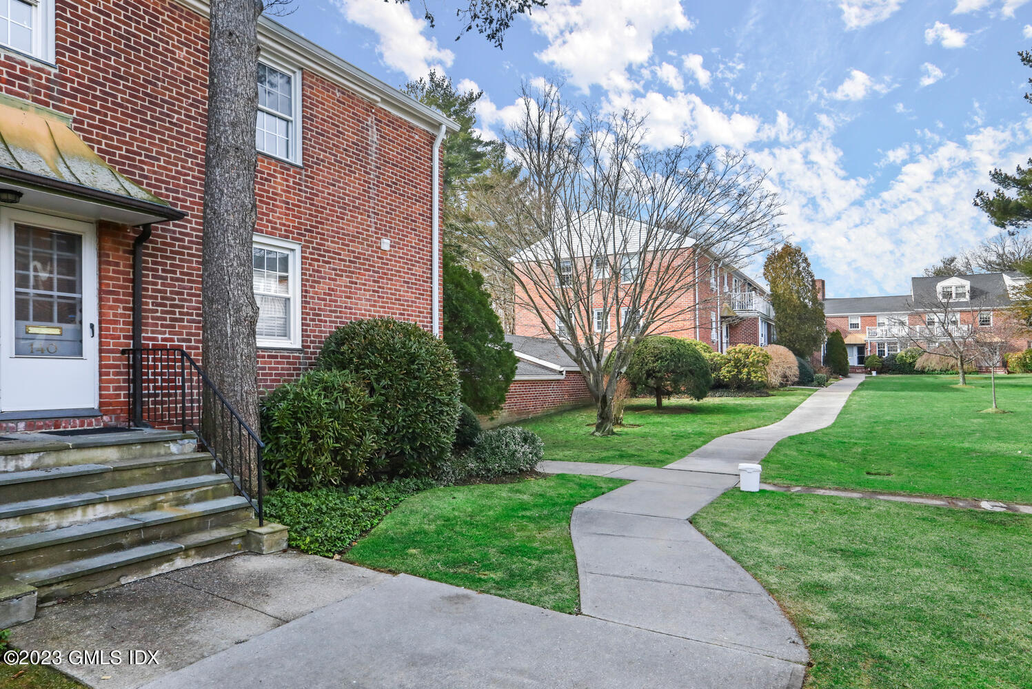 140 Putnam Park, Unit 140 Greenwich, CT 06830 - Photo 13 of 15 a view of a house with a yard