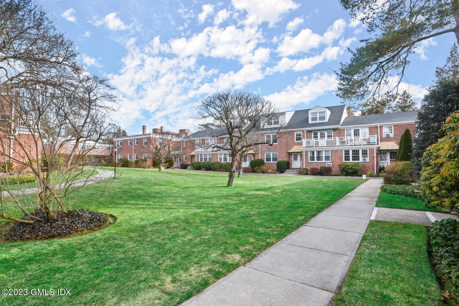 140 Putnam Park, Unit 140 Greenwich, CT 06830 - Photo 14 of 15 a view of a big building with a big yard and large trees