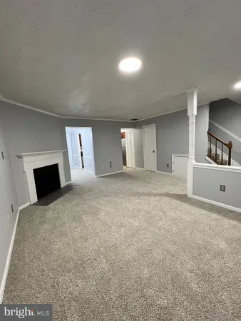 a view of an empty room with a fireplace
