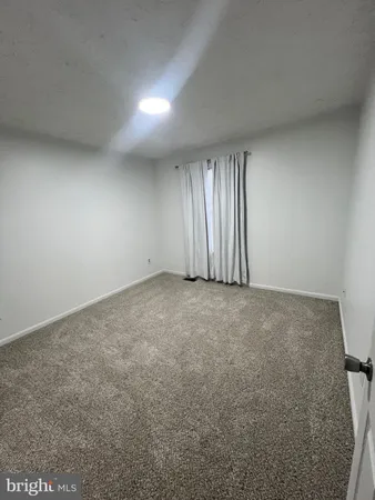 an empty room with a empty space and windows