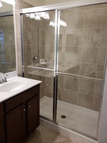 a bathroom with a shower and a sink