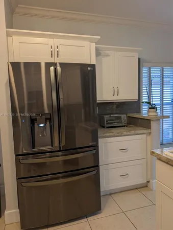 a refrigerator freezer sitting inside of a kitchen