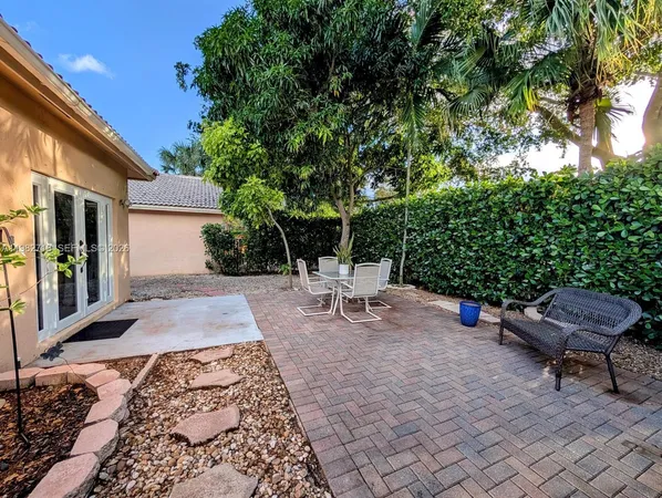 a view of a backyard with sitting area