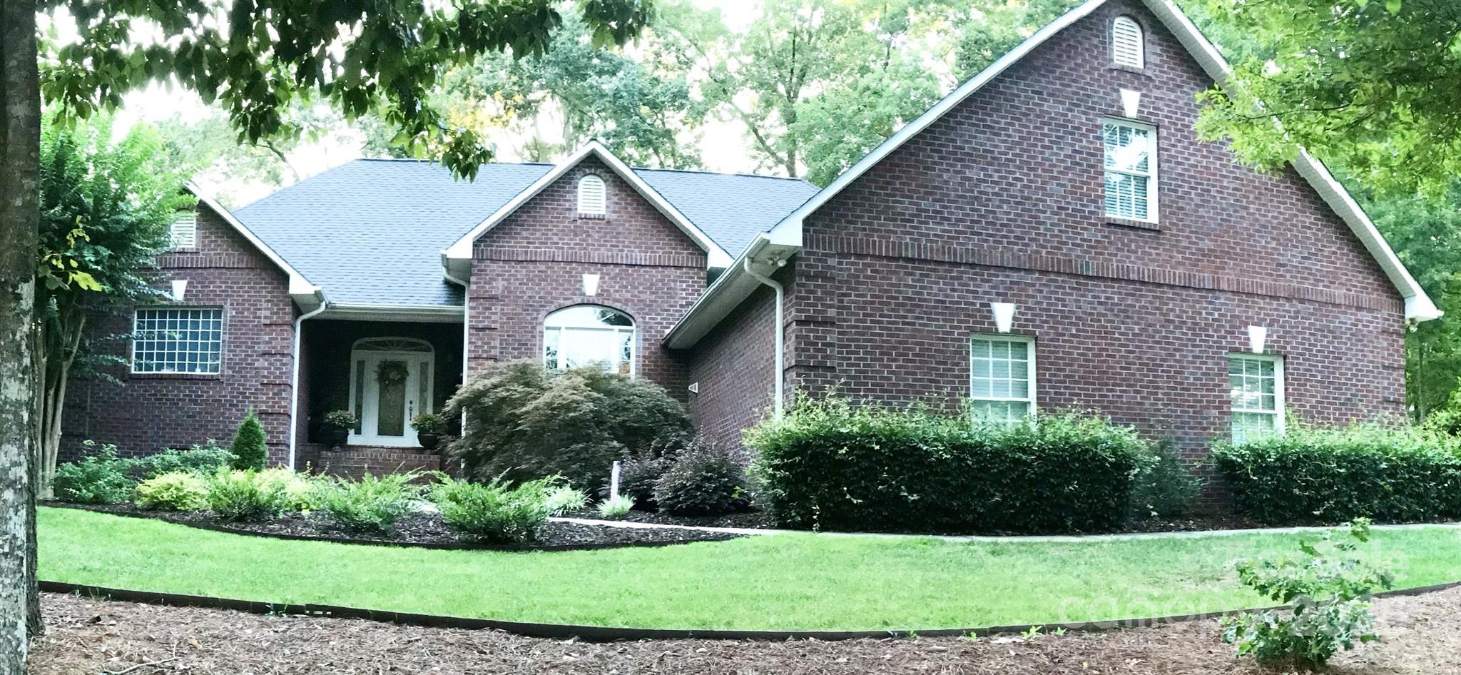 134 Chisholm Trail Rutherfordton, NC 28139 - Photo 1 of 48 a front view of a house with a yard