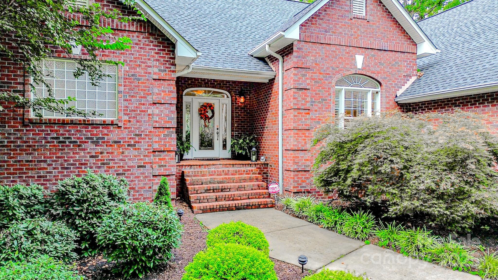 134 Chisholm Trail Rutherfordton, NC 28139 - Photo 2 of 48 a front view of a house with garden