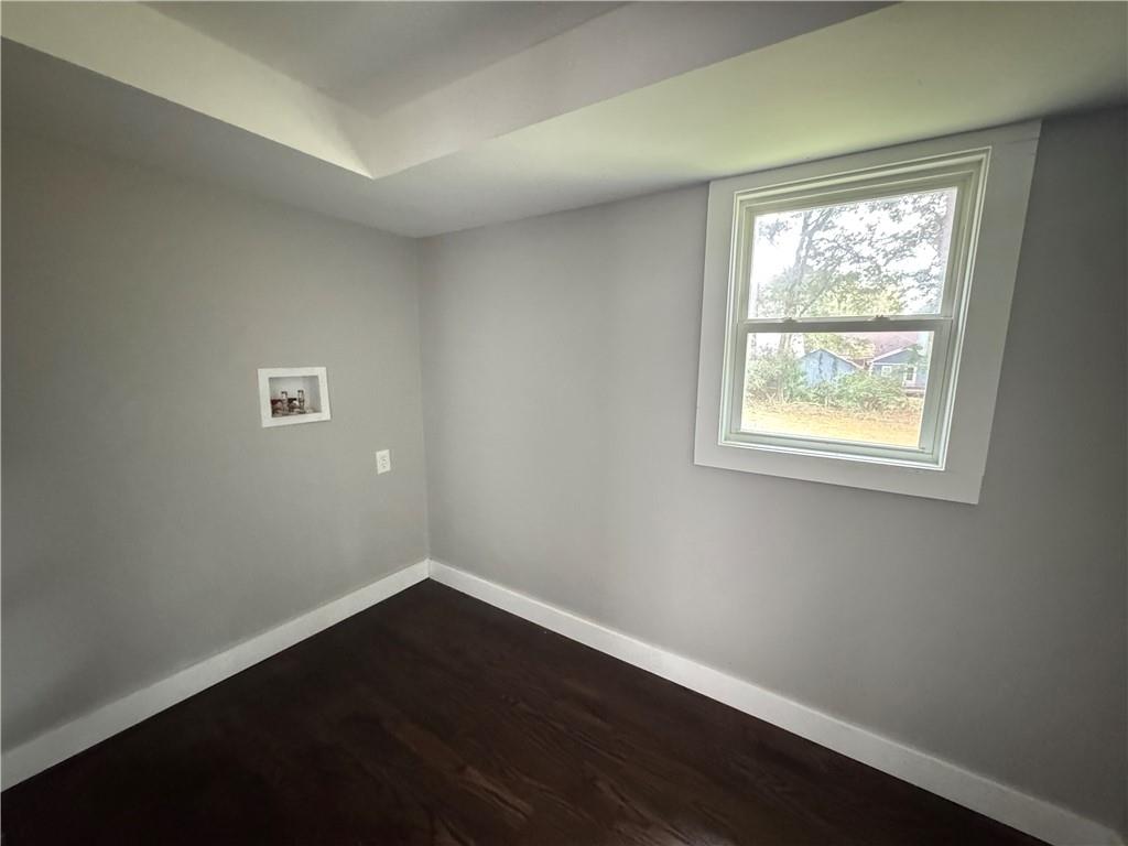 1714 Emerald Avenue Southwest Atlanta, GA 30310 - Photo 13 of 16 a view of an empty room with wooden floor and a window