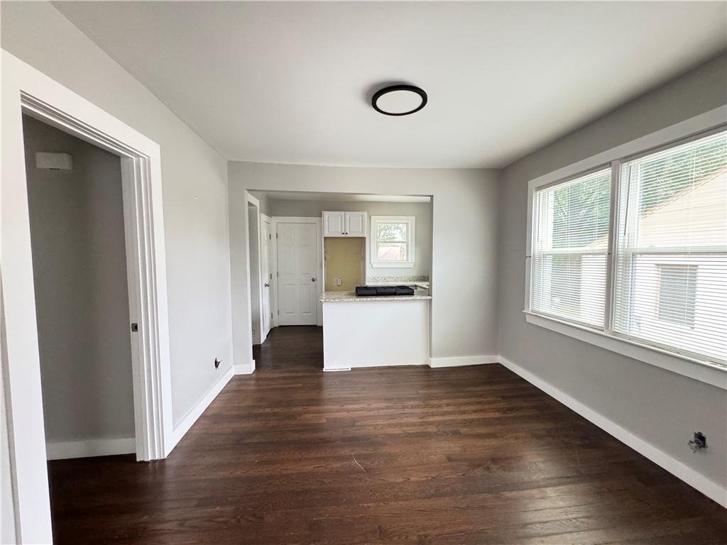 1714 Emerald Avenue Southwest Atlanta, GA 30310 - Photo 15 of 16 a view of an empty room with wooden floor and a window