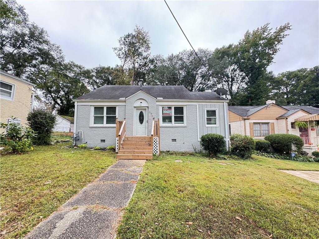 1714 Emerald Avenue Southwest Atlanta, GA 30310 - Photo 2 of 16 a front view of a house with a yard