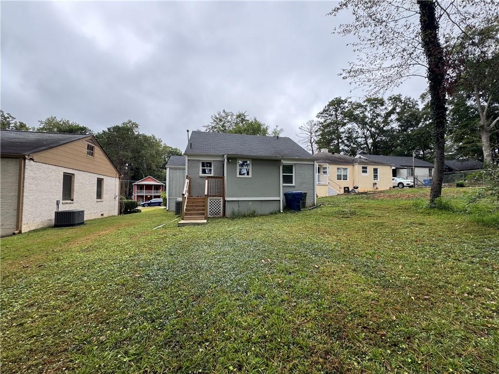 1714 Emerald Avenue Southwest Atlanta, GA 30310 - Photo 5 of 16 a front view of a house with a garden and yard