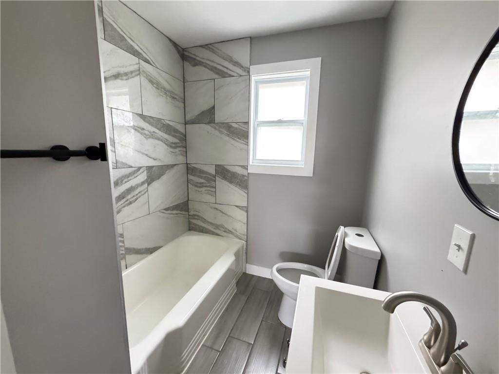 1714 Emerald Avenue Southwest Atlanta, GA 30310 - Photo 7 of 16 a bathroom with a bathtub and toilet