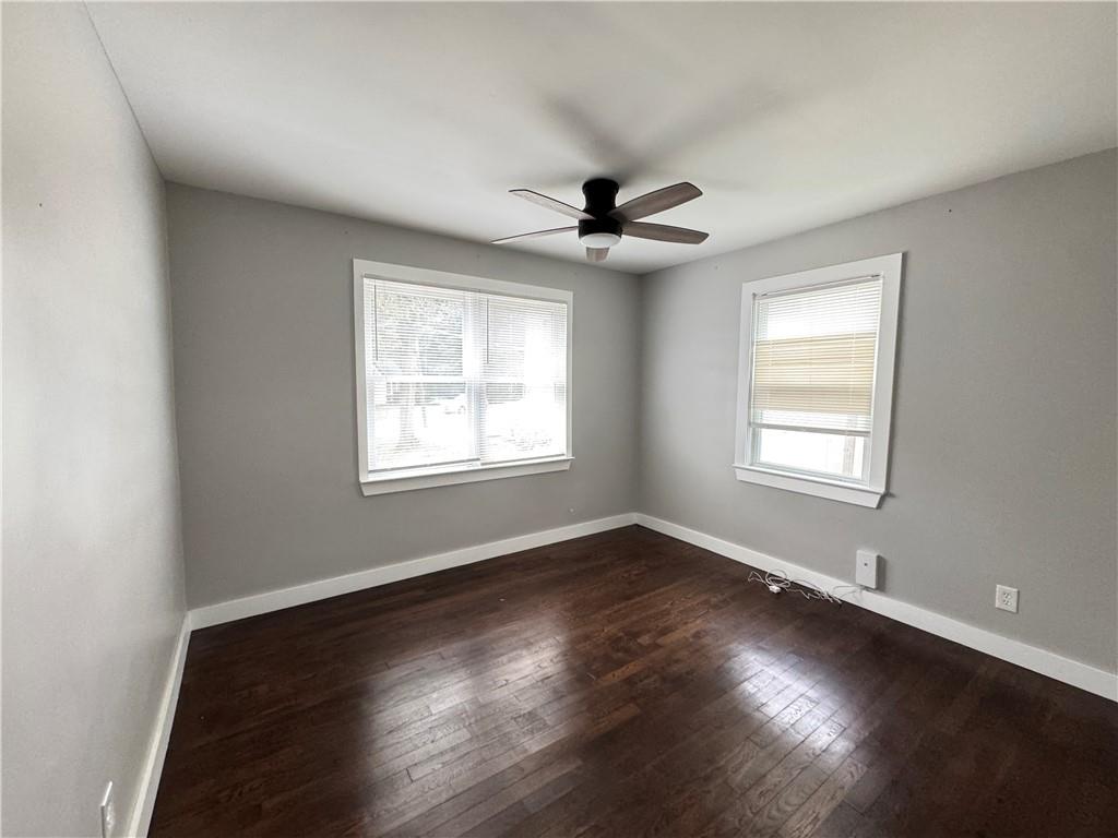 1714 Emerald Avenue Southwest Atlanta, GA 30310 - Photo 9 of 16 a view of an empty room with wooden floor and a window