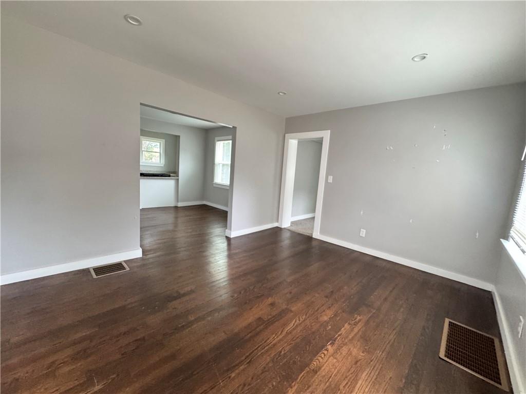 1714 Emerald Avenue Southwest Atlanta, GA 30310 - Photo 10 of 16 a view of an empty room with wooden floor and a window