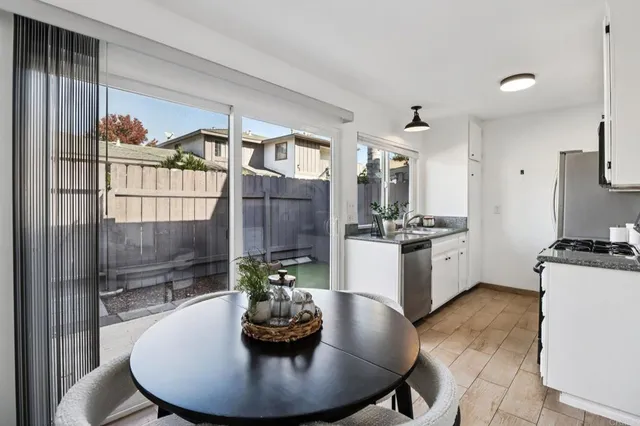 a kitchen with a table and chairs