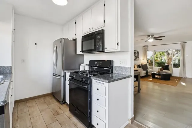 a kitchen with stainless steel appliances a stove a refrigerator and a cabinets