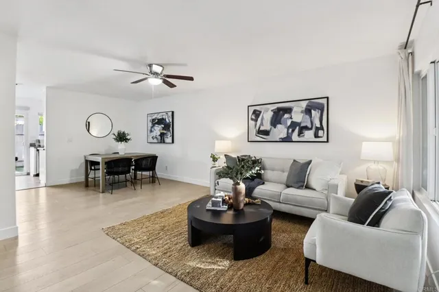 a living room with furniture and a chandelier