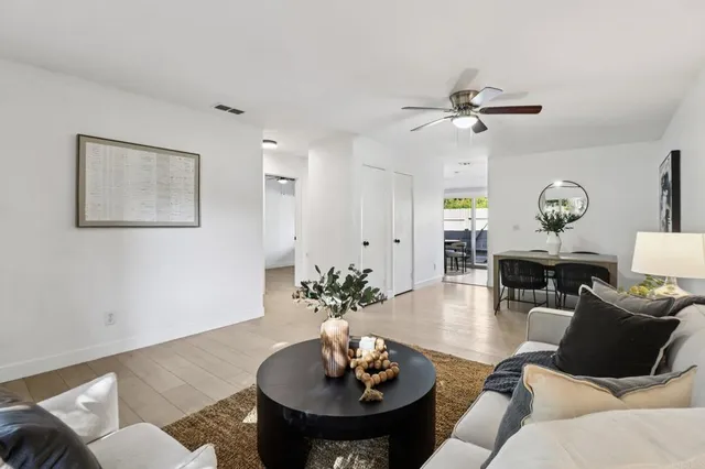 a living room with furniture a clock and a mirror