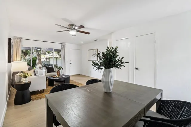 a view of a dining room with furniture and a potted plant