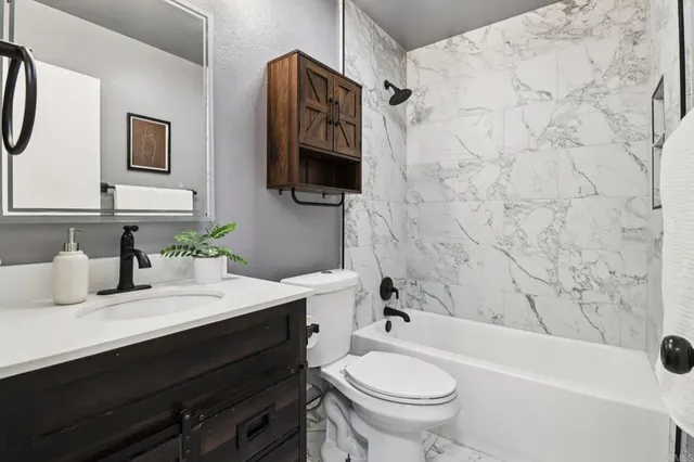 a bathroom with a sink a toilet and a bathtub