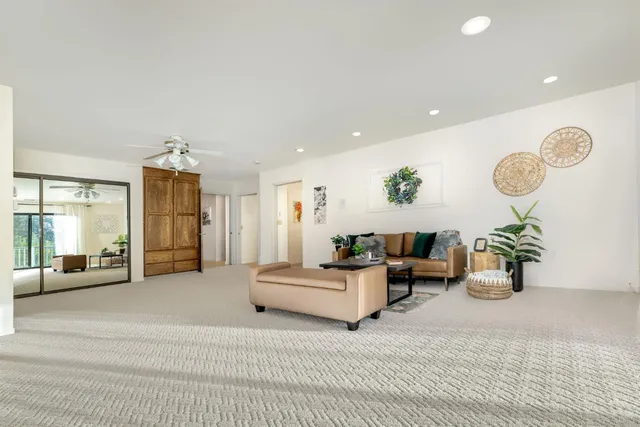 a living room with furniture and a floor to ceiling window