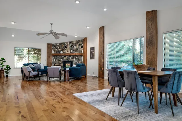 a dining room with furniture window and wooden floor