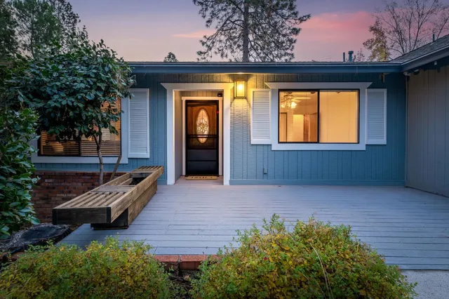 a view of a livingroom with furniture water view and large windows